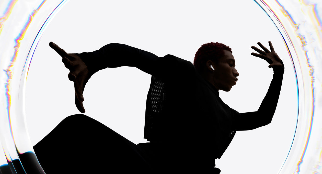 A dancer uses AirPods Pro 3 as they move to a beat with their arms spread wide