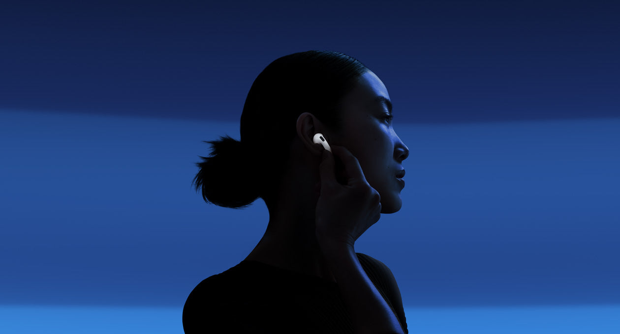 A person enabling Active Noise Cancellation by touching the stem.