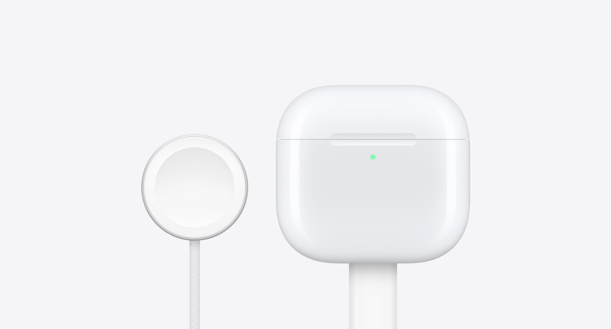 The AirPods 4 charging case alongside an Apple Watch charger.